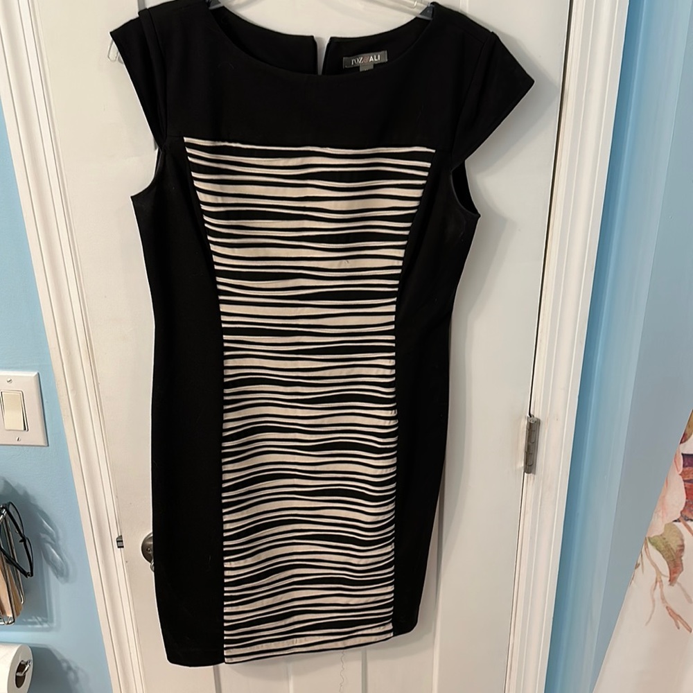 Black dress with cream design on fro t if dress. Size12 polyester spandex